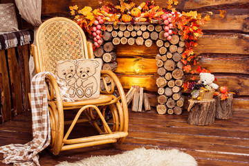Fireplace collected from logs, rocking-chair and furs in the roo