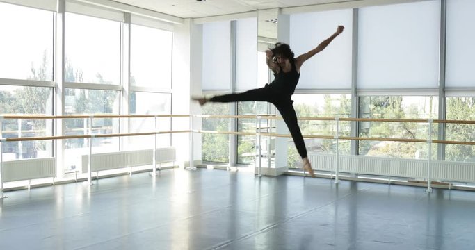 Dancing man modern ballet dancer performs dance in studio