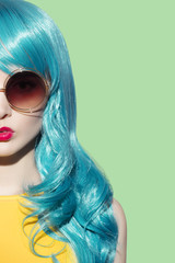 Pop art woman wearing blue curly wig and bright yellow dress. Cl