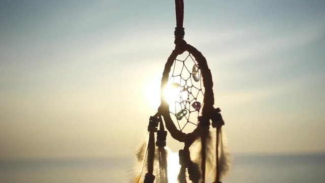 Dream Catcher Swinging at the Sea Sunset. Slow Motion