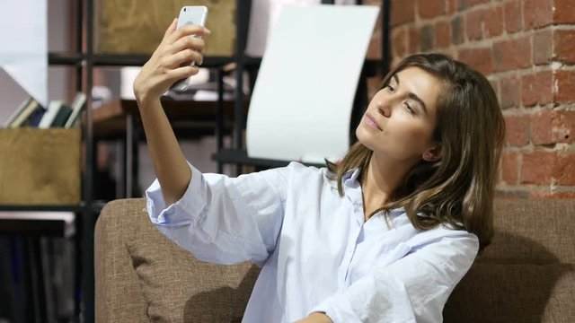 Sitting Beautiful Lovely Girl Taking Selfie with Smartphone