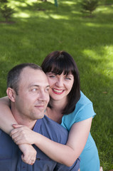 Fototapeta premium Woman hugging a man's neck 