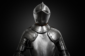 Old metal knight armour on black background