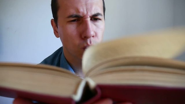 man thinks reading video a book sitting in the room
