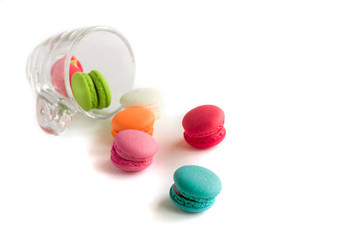 Macaroons sweet colorful on floor and cup on white background