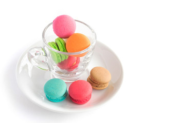 French macaroons colorful on glass cup with white background, sweet and dessert menu,selective focus