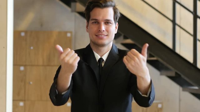 Inviting Gesture by Young Man in Suit