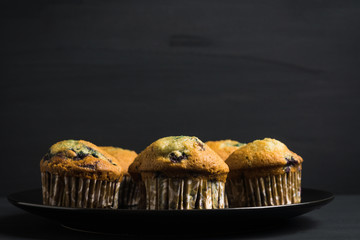 Homemade muffins with strawberries on the wooden background. Selective focus.