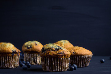 Homemade muffins with strawberries on the wooden background. Selective focus.