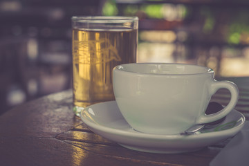 Retro style or Vintage Style, Black Coffee cup Put on a stump or wood table in the garden sunny morning.
