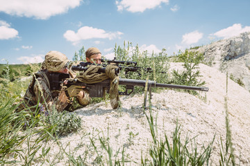 Army sniper during the military operation in the mountain. war,