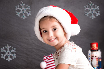 Portrait of cute  baby girl in a red Christmas hat