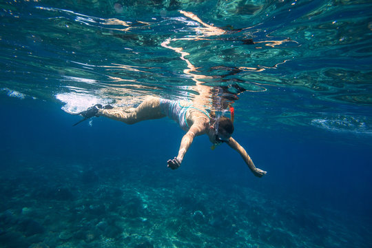 Young Women Snorkeling in the Tropical Water © trubavink