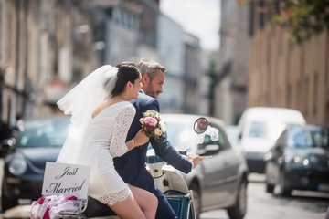 Portrait of newlyweds on a decorated vintage scooter © jackfrog