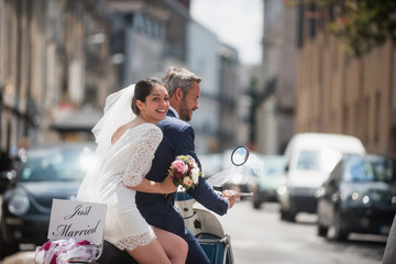 Portrait of newlyweds on a decorated vintage scooter © jackfrog