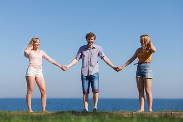 Carefree friends by sea ocean water.