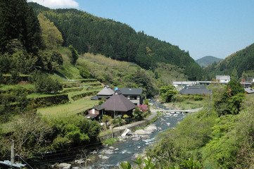 This scenery is one of the typical Japanese mountain village. This photo was taken  in April. The house has built beside of a small river stream.