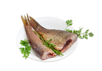 Two hot smoked grass carp on a white dish