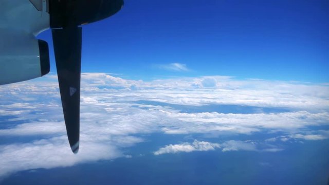 Slow Motion View from Over the Clouds inside a Airplane with Propellers