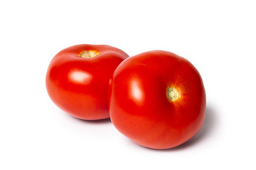 Two tomatoes isolated on white background