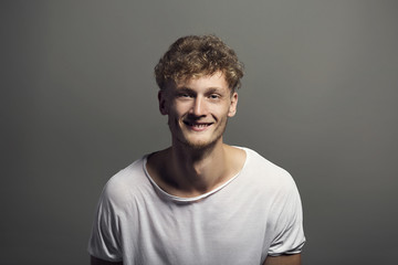 Fototapeta premium Handsome emotional man with a smile posing