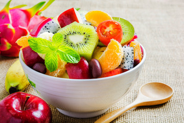 Diet-Fresh tasty mix fruit salad in the bowl on the sackcloth ba