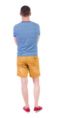 Back view of handsome man in shorts. Rear view people collection.  backside view of person.  Isolated over white background.