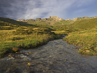 Alpine creek in an autumnal alpine landscape at sunrise