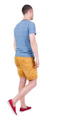 Back view of going  handsome man in shorts.  walking young guy . Rear view people collection.  backside view of person.  Isolated over white background.
