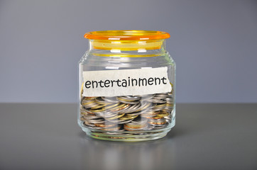 Saving concept of coins in the glass jar for entertainment  purp