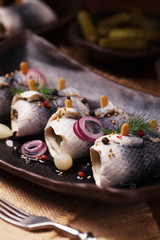 Rolled herring in vinegar, served with onions and pickles.