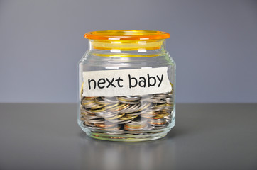 Saving concept of coins in the glass jar for nexy baby  purpose