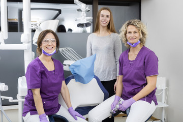 Female Dentists With Young Patient Smiling In Clinic