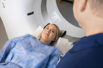 Patient Looking At Radiologist While Lying On MRI Machine