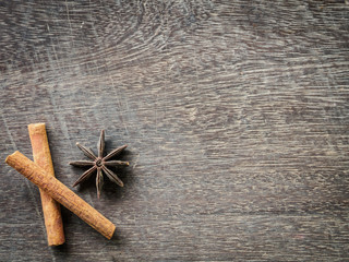 Fototapeta na wymiar Top view of cinnamon and star anise on wooden background