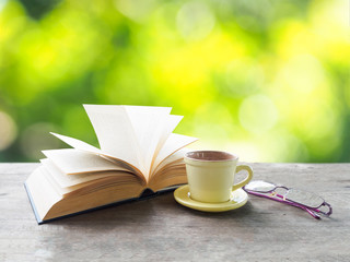 Coffee cup, book and glasses for reading relax time in morning o