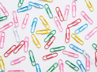 Top view colorful paperclips on white background
