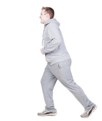 back view of running athlete man in tracksiut . walking sportsman in motion. Rear view people collection.  backside view of person. Isolated over white background. 