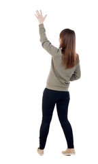 Back view of beautiful woman welcomes. Young teenager girl in dress hand waving from. Rear view ...