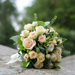 Bouquet of white roses close. Festive and wedding accessory. Romantic view of the flowers of the bride.