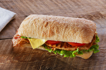 Sandwich with grilled chicken tomato bacon cheese