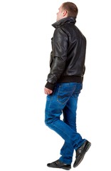 Naklejka premium Back view of going handsome man in jeans and jacket. walking young guy in jeans and jacket. Rear view people collection. backside view of person. Isolated over white background.