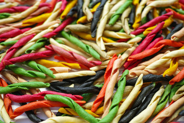 Traditional colorful Italian dried homemade pasta fusilli with eight colors