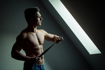 Fototapeta na wymiar Sexy muscular man with belt