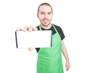 Selective focus of supermarket seller showing blank screen phone