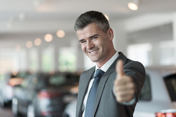 Car salesman giving a thumbs up