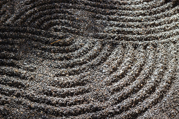 Zen stone garden and patterns tranquil scene for relaxation and meditation simplicity background with light and shadow