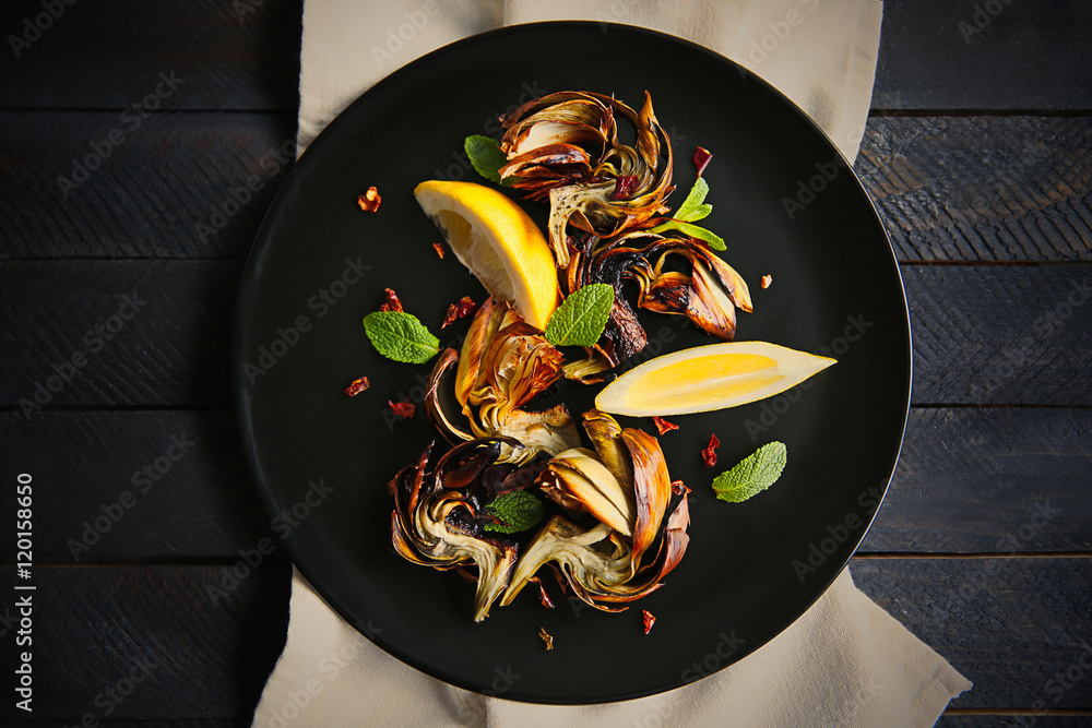 Sticker baked artichokes with spices on wooden background