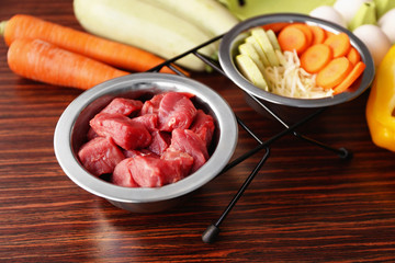 Healthy dog food on wooden background