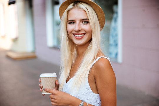 Close Up Of Girl In Hat Holding Take Away Cup